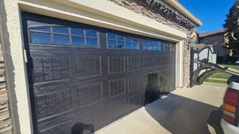 New dark garage door with window inserts