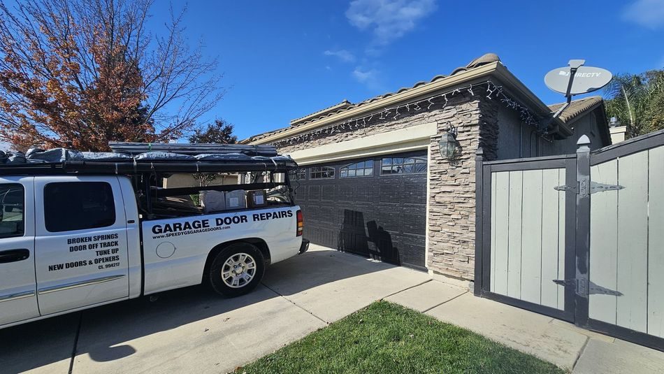 Speedy G's service truck at a finished garage door and gate job in Elk Grove